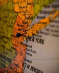 A close-up on the map of New York (state) with a pin in New York (country). Who knows, maybe the pin pin-pointed Elmhurst!